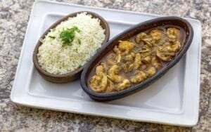 A healthy Mediterranean dish from Dearborn featuring a plate of rice and a flavorful bowl of stew.