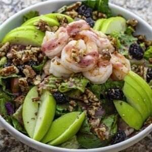 A Mediterranean salad with shrimp, apples, and walnuts.