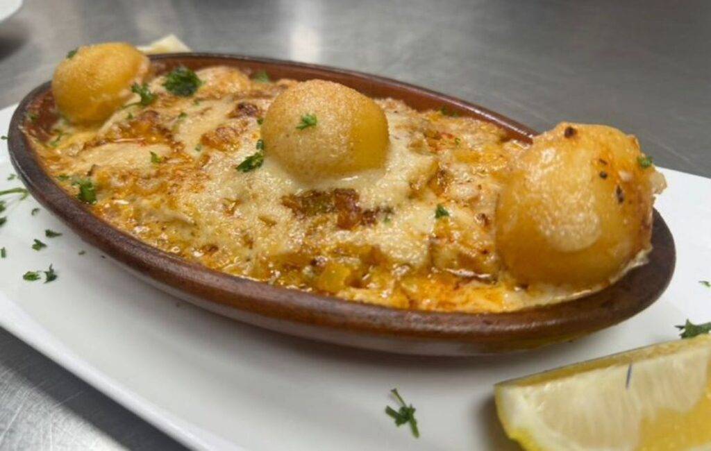 Aliz Seafood & Grill A baked dish from Aliz_Seafood_Grill_House_, topped with three browned cheese balls and garnished with chopped herbs, served on a white plate with a lemon wedge. Dearborn MI Aliz Seafood & Grill A baked dish from Aliz_Seafood_Grill_House_, topped with three browned cheese balls and garnished with chopped herbs, served on a white plate with a lemon wedge. Dearborn MI