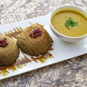 A plate with two desserts and a bowl of soup, incorporating health food.