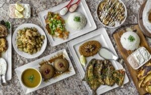 A variety of Mediterranean seafood dishes on plates, displayed elegantly on a table in Sterling Heights.