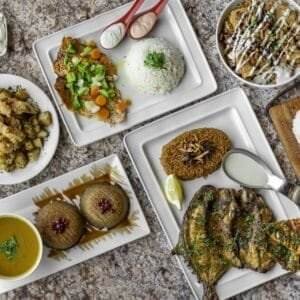 A variety of Mediterranean health food on plates on a table.